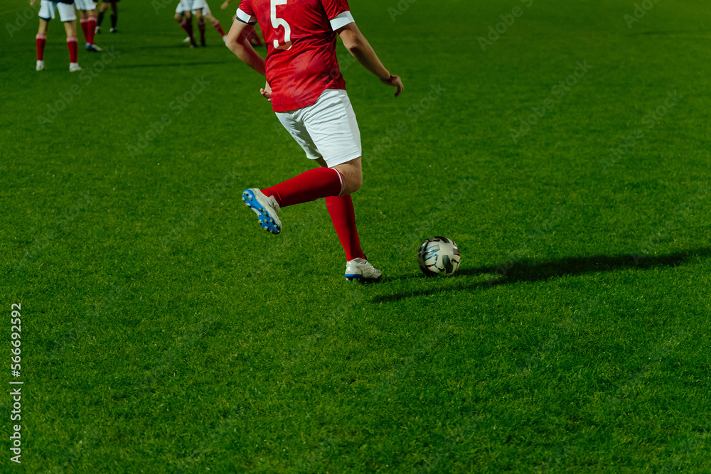 football player hits ball during football match football player hits ball during football match