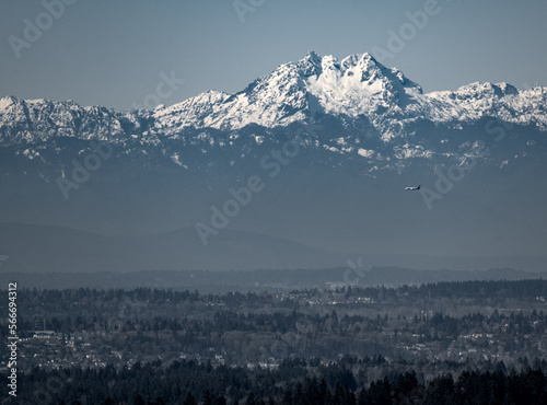A view of the Olympic Mountains and airplane in front