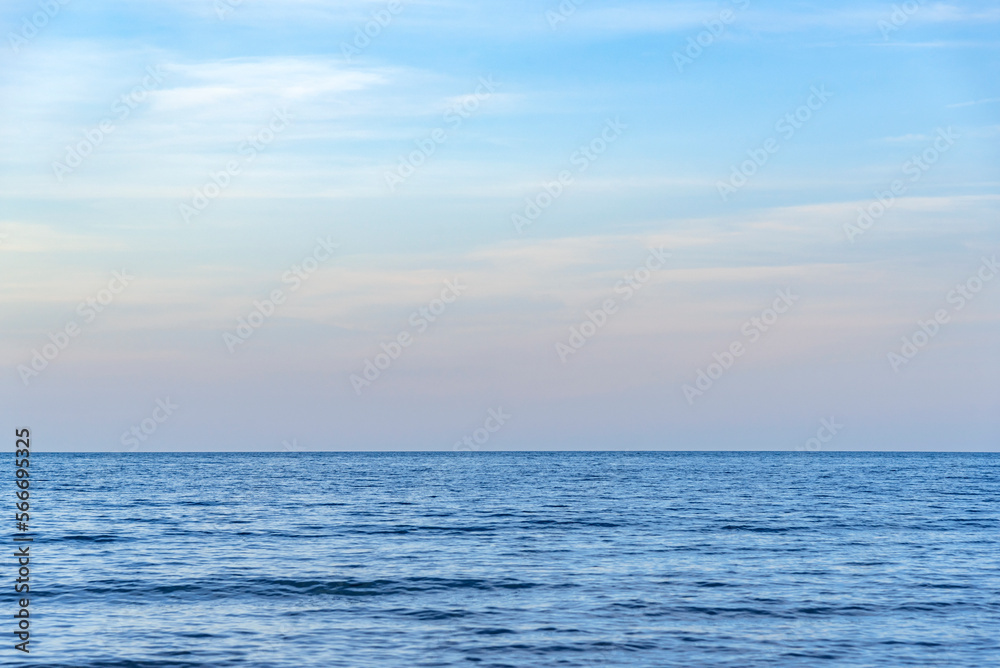 Beautiful evening sky at sunset and sea surf. Sea and waves against the blue sky.