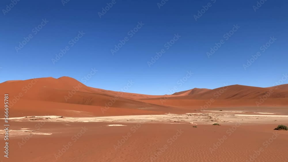 Camera pan over Namib desert. The dunes start to glow red at late afternoon. Camera pan over Namib desert. The dunes start to glow red at late afternoon.