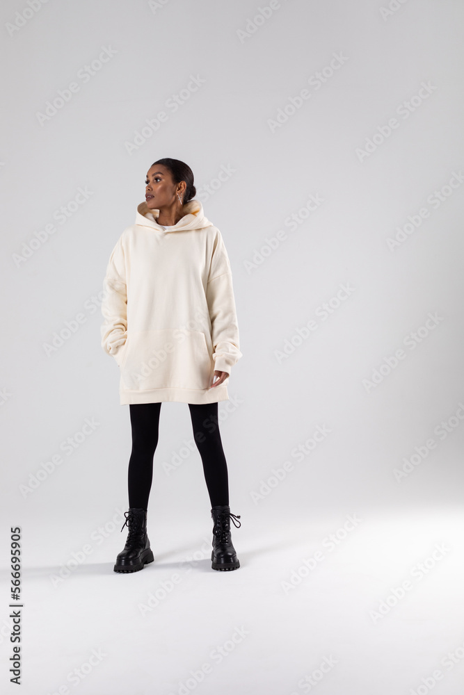 Attractive african american woman in oversized white hoodie. Mock-up. Attractive african american woman in oversized white hoodie. Mock-up.