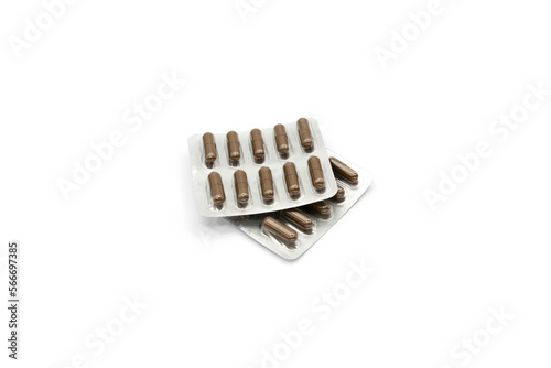 Two blister packs with brown capsules isolated on a white background.