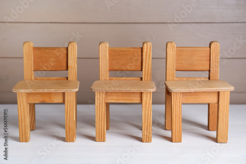 Small toy chairs on white wooden table