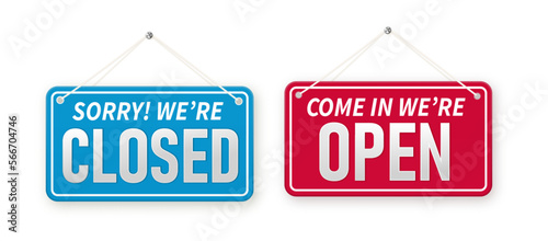 Information boards with Come in we're open and Sorry, We are closed. White signboard with a rope on background. Business concept for closed and open businesses, sites and services