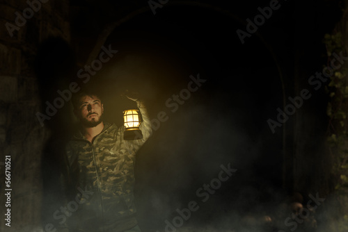 Fototapeta Naklejka Na Ścianę i Meble -  young man exploring with a lantern
