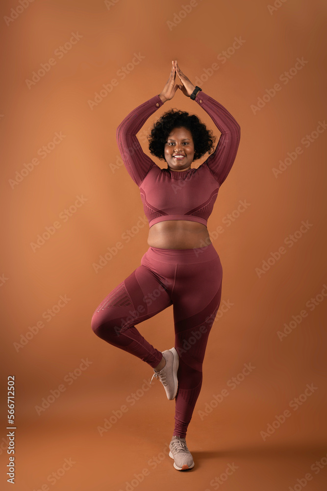 body positive curvy black girl wearing sportswear in studio doing yoga and  exercising Stock Photo