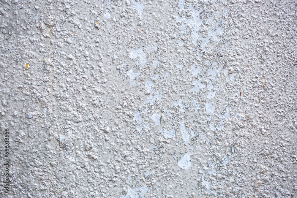 Texture of paint stains on the wall, cracked paint on an old metal surface. Sheet of silver metal with cracked and peeling paint, background for design with copy space. Texture of paint stains on the wall, cracked paint on an old metal surface. Sheet of silver metal with cracked and peeling paint, background for design with copy space.