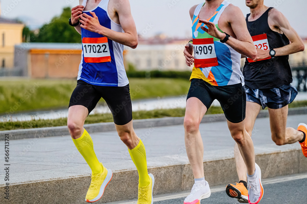 group of male runners run marathon race
