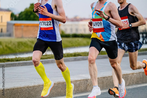 group of male runners run marathon race