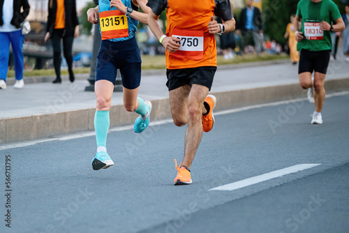 male runners run city marathon