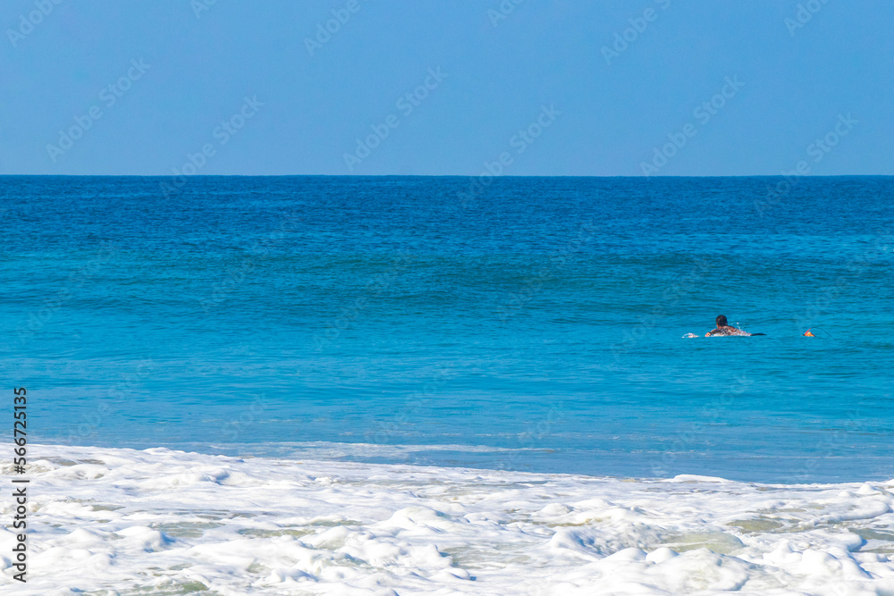 Surfer surfing on surfboard on high waves in Puerto Escondido Mexico.