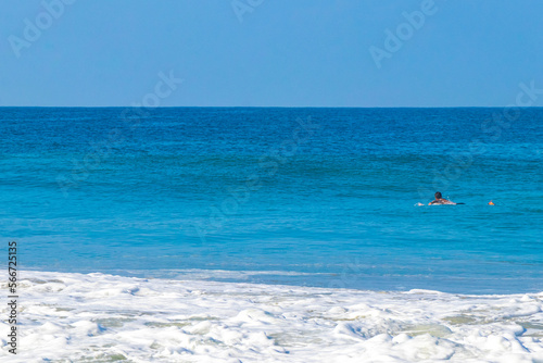 Surfer surfing on surfboard on high waves in Puerto Escondido Mexico.