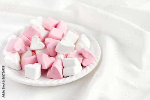 Pink and white marshmallows heart shape. Fluffy sweets for love theme or Valentine concept in pastel tone.