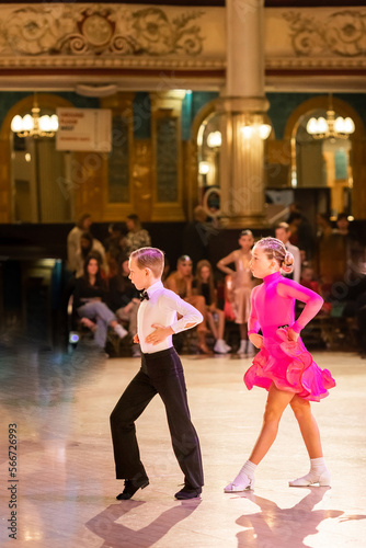 Attractive young couple of children dancing ballroom dance. Girl and boy dancer international dancing. photo