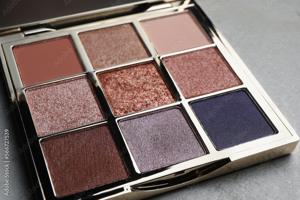Beautiful eye shadow palette on grey table, closeup Beautiful eye shadow palette on grey table, closeup