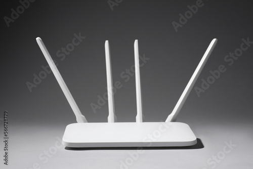 New stylish Wi-Fi router on grey background photo