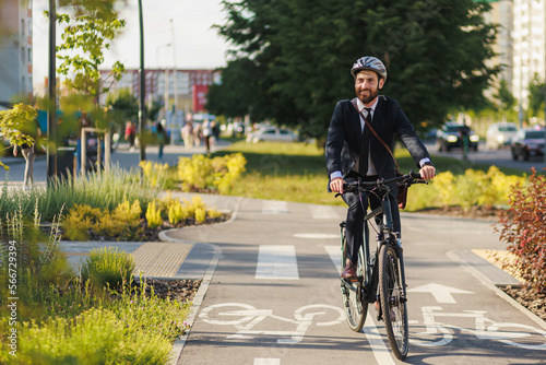 Happy office clerk in smart casual riding home on bikeway.