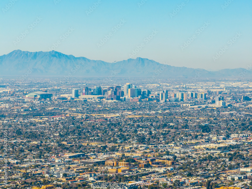 Phoenix downtown modern city skyline aerial view with Estrella Mountain at back, from the top of Camelback Mountain in city of Phoenix, Arizona AZ, USA. 