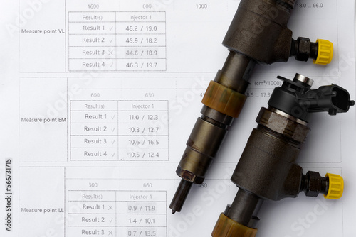 Diagnostics of diesel injectors. Car diesel injectors and test results isolated on white background.