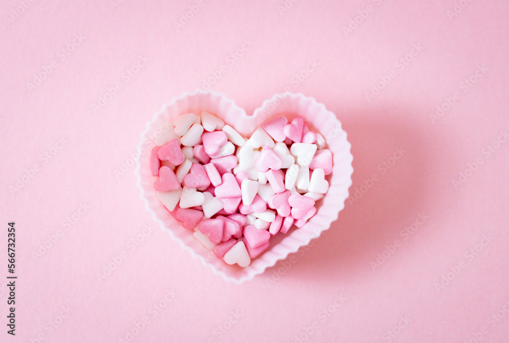 One form for a muffin heart with candy sprinkles on a pink background.