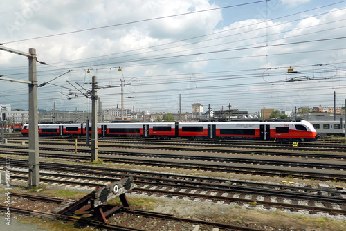 Cityjet train of Austrian Federal Railways on the rail tracks on sunny day photo