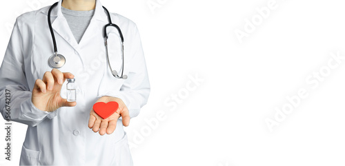 The girl doctor holds in one hand a red heart in the other ampoule with the medicine. Woman doctor in white coat isolated on a white background, stethoscope, treatment, hospital, care, recovery