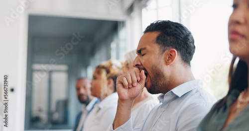 Tired, yawn and sleepless with a business man sitting in a meeting or presentation with his team for development. Yawning, exhausted and bored with a male employee suffering from insomnia at work