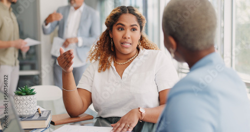 Paperwork, discussion and business women in the office analyzing company review, proposal or report. Documents, professional and female corporate employees in conversation working on project together