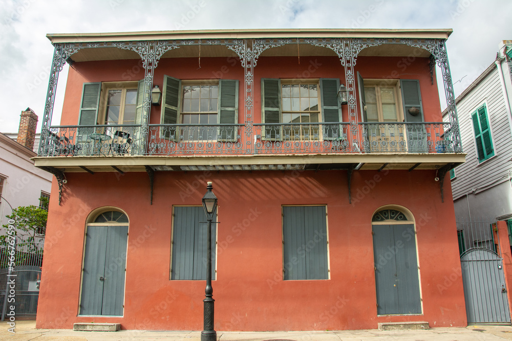 French colonial era brick building with Creole style wrought iron railings in the French Quarter, also known as the Vieux Carre neighborhood of New Orleans, Louisiana, USA