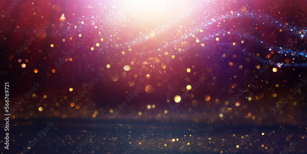 background of abstract glitter lights. gold, purple and black. de focused