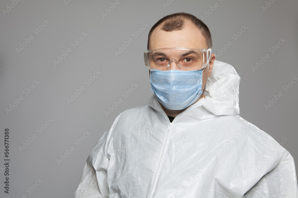 Scientific virologist. Biologist in protective suit and blue gloves. Viruses concept. Virus University employee. Scientific virologist. Biologist in protective suit and blue gloves. Viruses concept. Virus University employee.