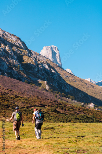 Dos senderistas se preparan para subir una montaña, Picos de Europa, Asturias, España photo