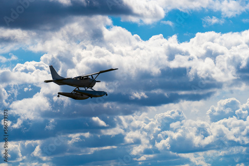 Cuadro en lienzo Seaplane flying in the cloudy blue sky