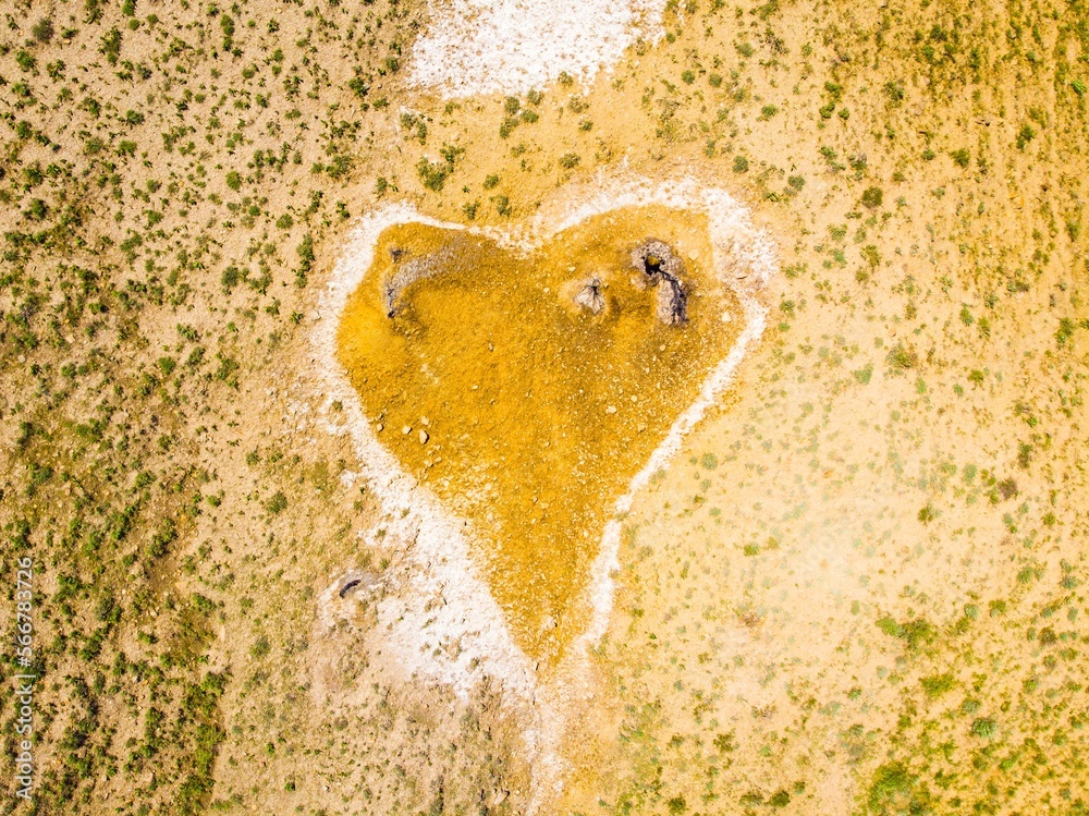 Obraz premium Top down view orange heart shape form on mud volcanoes site in chachuna nature reserve, VAshlovani national park, Georgia