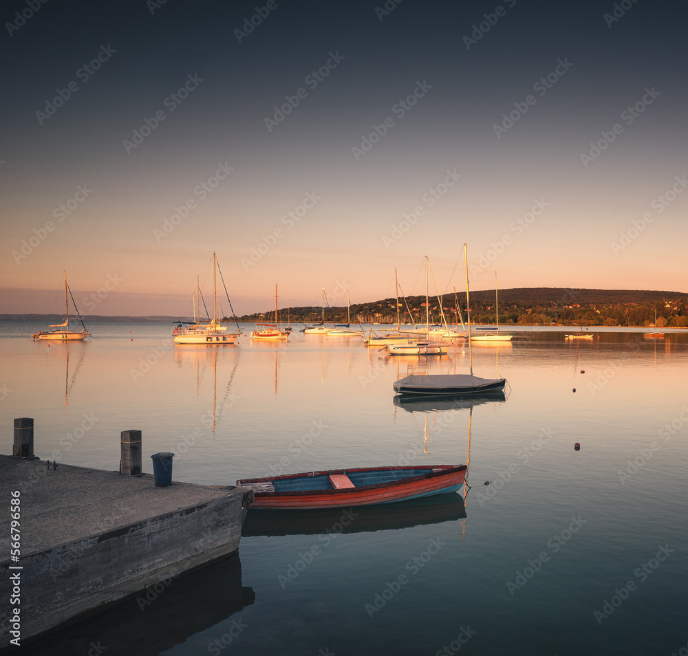 Relaxing morning at lake Balaton with sailboats in the summer