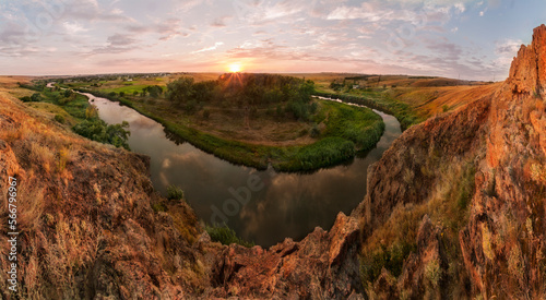 The river bent around granite massifs near the Ukrainian village of Starolaspa at sunset. Bend of a river.
