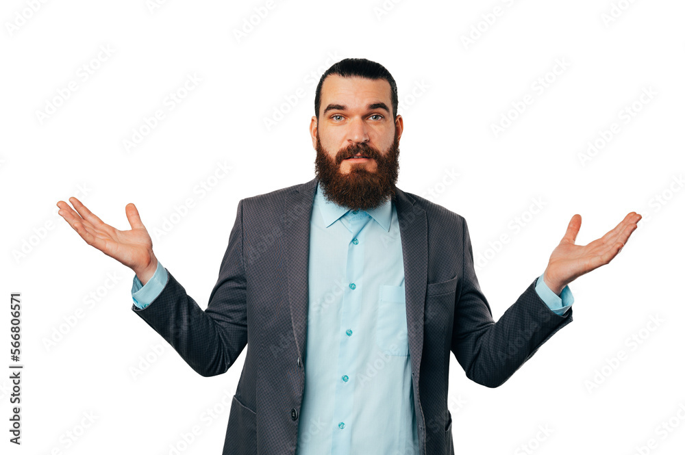 Unsure young bearded man wearing shirt and a grey jacket is shrugging. Unsure young bearded man wearing shirt and a grey jacket is shrugging.