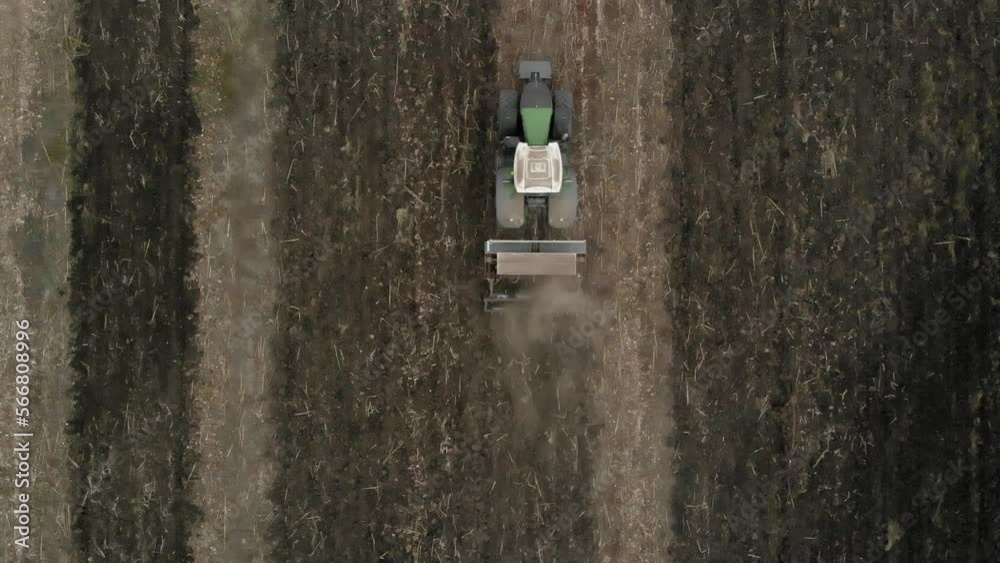 Tractor working in the field. Autumn tillage. Deep ripping with powerful tractor Tractor working in the field. Autumn tillage. Deep ripping with powerful tractor