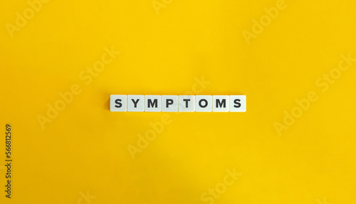 Symptoms Word on Block Letter Tiles on Yellow Background. Minimal Aesthetics.