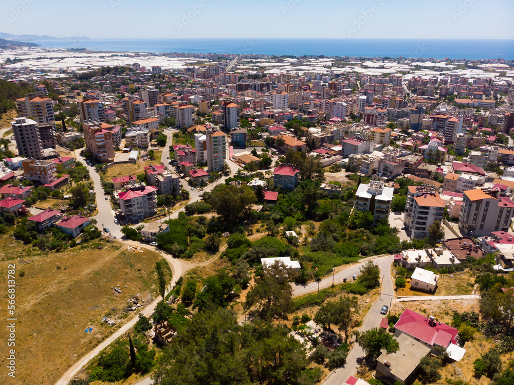 Picturesque aerial view of Turkish town of Anamur on Mediterranean coast overlooking many huge greenhouses on sunny spring day..