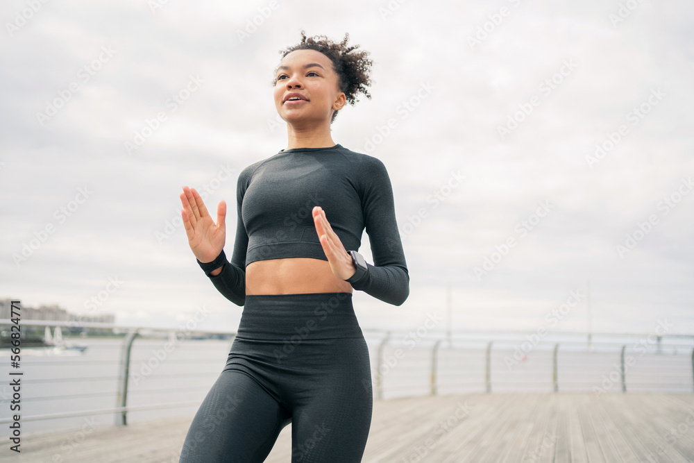 Fototapeta premium Fitness workout a slender woman in sportswear doing an outdoor workout.