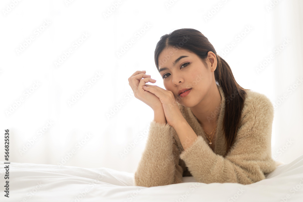 Portrait of smiling cheerful beautiful pretty asian woman clean fresh healthy white skin posing smile in pajamas white clothes.Girl felling relax and enjoy time on the bed at home.asia beauty Portrait of smiling cheerful beautiful pretty asian woman clean fresh healthy white skin posing smile in pajamas white clothes.Girl felling relax and enjoy time on the bed at home.asia beauty
