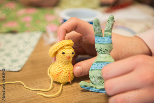 Girl holding handmade chick and rabbit photo