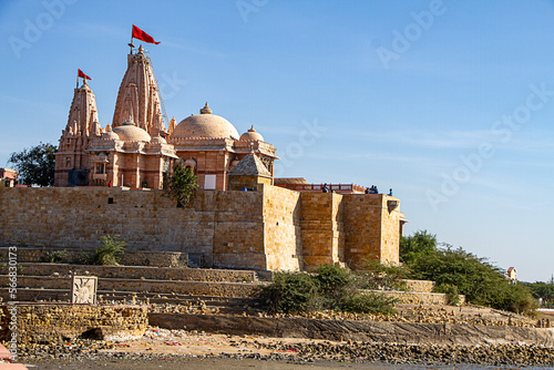 Koteshwar Mahadev Temple with Red pendant flying on top situated in Koteshwar Gujarat at the Kori Creek during low tide photo