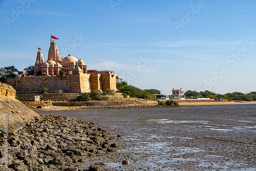 Koteshwar Mahadev Temple with Red pendant flying on top situated in Koteshwar Gujarat at the Kori Creek during low tide