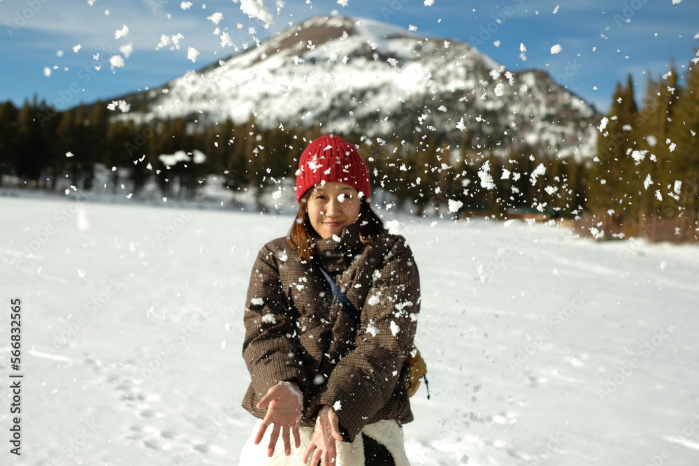 A young woman playing snow in the mountain. Outdoor activity during winter season and happy moment. A young woman playing snow in the mountain. Outdoor activity during winter season and happy moment.