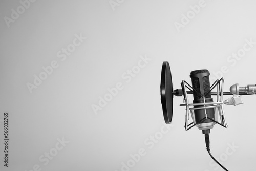 a microphone on gray background with copy space. podcasting background. 