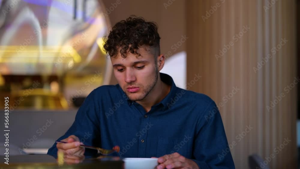 Close up of Caucasian handsome man having lunch or supper eating in restaurant alone. Young businessman eats tasty meal. Diet. Food concept. Healthy lifestyle. Real time. Close up of Caucasian handsome man having lunch or supper eating in restaurant alone. Young businessman eats tasty meal. Diet. Food concept. Healthy lifestyle. Real time.