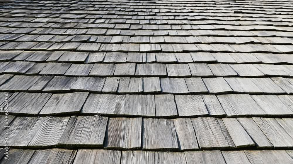 Wood shingle roof on house. Grey wooden shake roof, close up. Textured.  