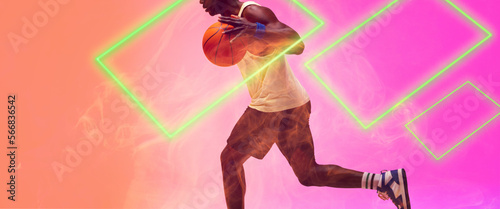 Low section of african american basketball player running and dribbling ball by rectangles